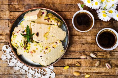 Halva with pistachio served with coffee clipart