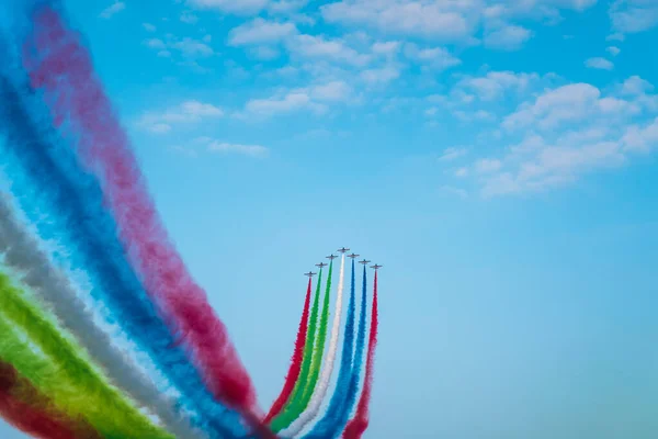 Jet planes leaving colorful trails on the sky during an airshow — Stock Photo, Image