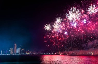 Fireworks over Abu Dhabi cityscape for the UAE national day cele clipart