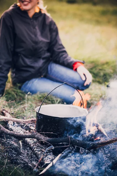 Summer camping food cooking on man and landscape background