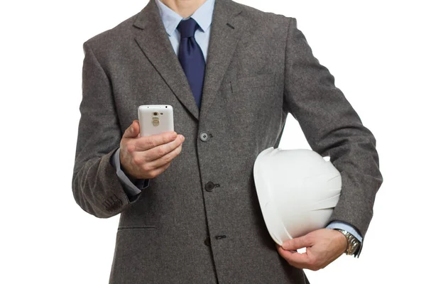 Бизнесмен в сером костюме с телефоном в руке и с п — стоковое фото