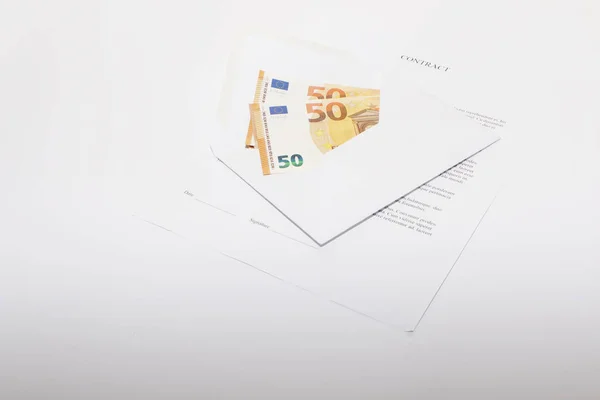 Business papers, contract and envelope with money.
