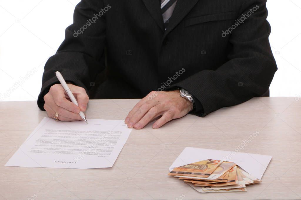 A businessman signs a contract and gives out cash.