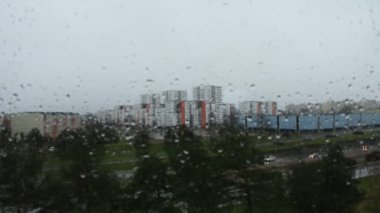 Şehir sokaklarında yağmurlu bir havada ofis penceresinden manzara.