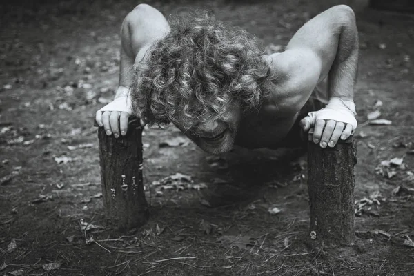 Domácí hřiště. Atlet houpačky svaly paže. — Stock fotografie