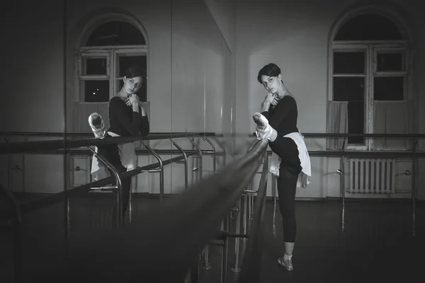 Ballet. Dancer warming up in the hall. Black and white photograp