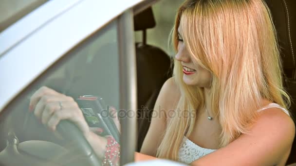 Dívka za volantem auta mluví po telefonu — Stock video