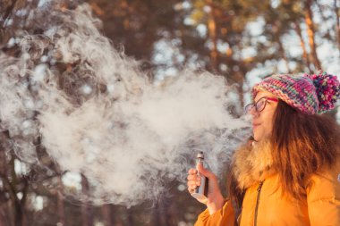 Elektronik sigara. Kız elektronik sigara içiyor.