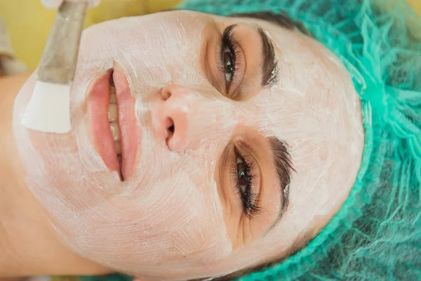 Máscara facial cosmética. Menina em um salão de beleza fazer uma máscara para o f — Fotografia de Stock