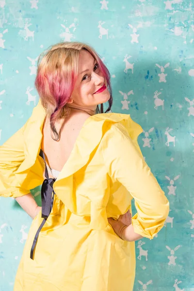 Clothing. Woman trying on a yellow dress — Stock Photo, Image