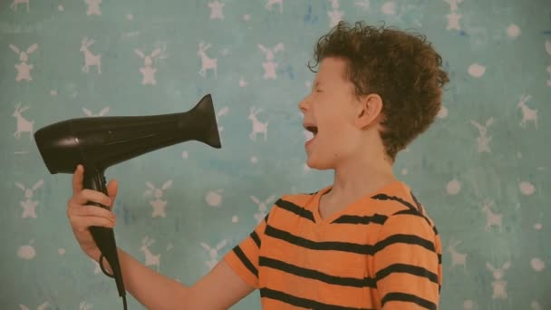 Boy drying his head with a hairdryer — Stock Video