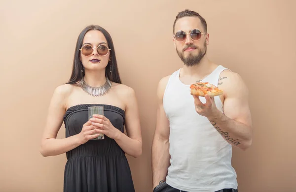 A girl drinks milk, and a guy eats pizza — Stock Photo, Image