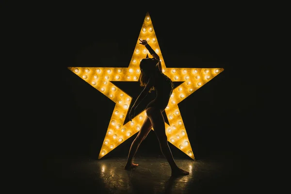 这个女孩跳舞一颗发光的星星背景 — 图库照片