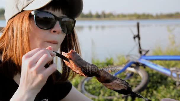 Picnic en la naturaleza. En la hoguera cocinan salchichas — Vídeo de stock