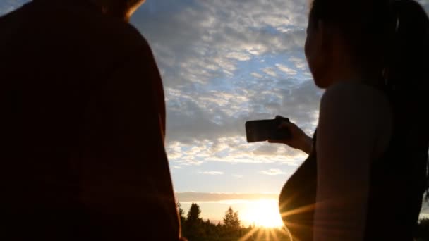 Fille et mec dans la nature regardant dans un téléphone mobile — Video