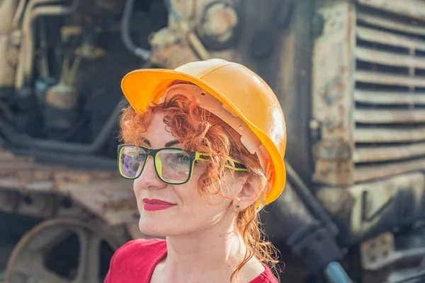 Woman is an engineer. Woman in a construction helmet