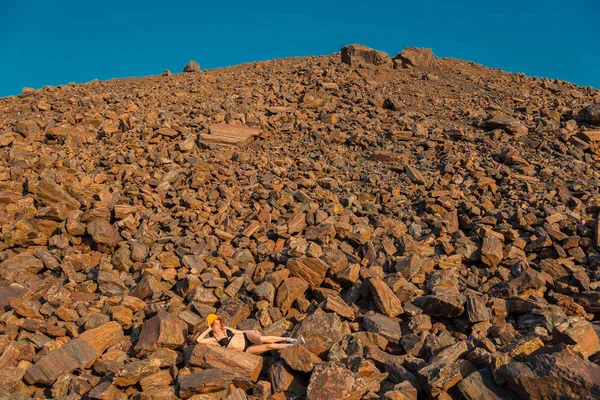 赤い鉱石。赤い鉱石の山。水着姿の女の子が re にあります。 — ストック写真