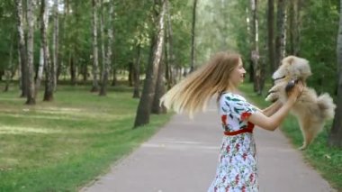 Bir kız ile bir köpek ile bir park yürüme mesafesindedir. Pomeranian Spitz