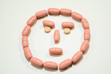 Pills. Tablets lined in the form of a face clipart