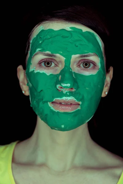 Mask for the face. Girl with green mask for face