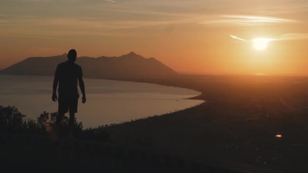 Подорож Хлопець Стоїть Вершині Гори Дивиться Захід Сонця — стокове відео