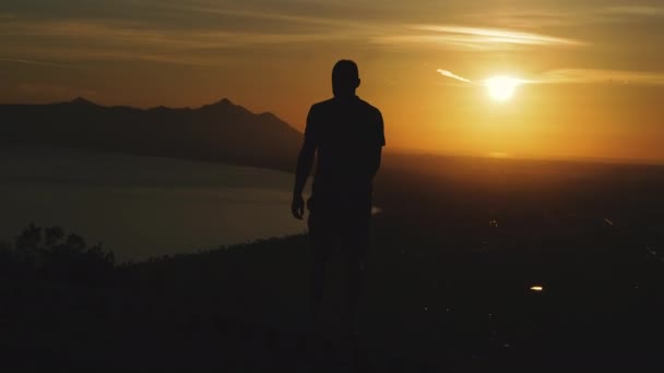 Journey Guy Stands Top Mountain Looks Sunset — Stock Video