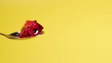 Dessert. Female hand takes a cherry jelly with a spoon.