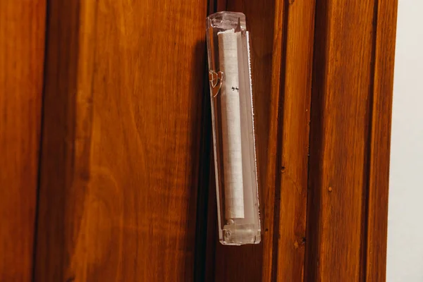 Mezuzah door jamb. Attaches to an external door jamb in a Jewish