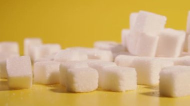 Sugar. Sugar in cubes lies on a yellow background.