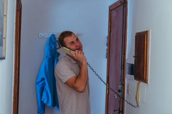 Landline phone. A man calls on a landline phone.