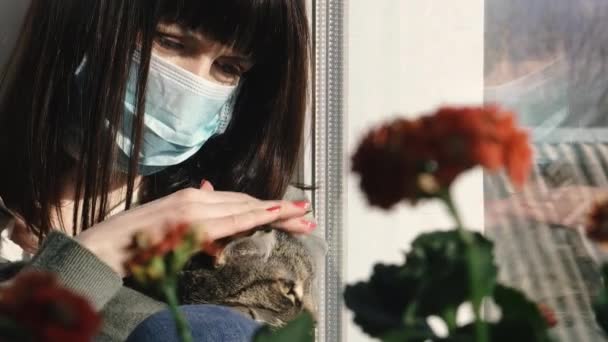 Virus Eine Frau Sitzt Mit Einer Katze Einer Mullschutzmaske Vor — Stockvideo