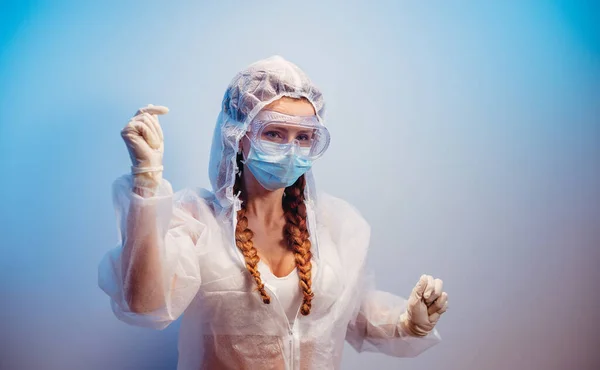 Virus. A woman in a transparent medical suit in a medical mask and glasses.