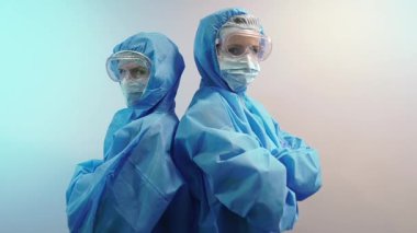 Virüs. Koruyucu antivirüs kıyafetli iki kadın..