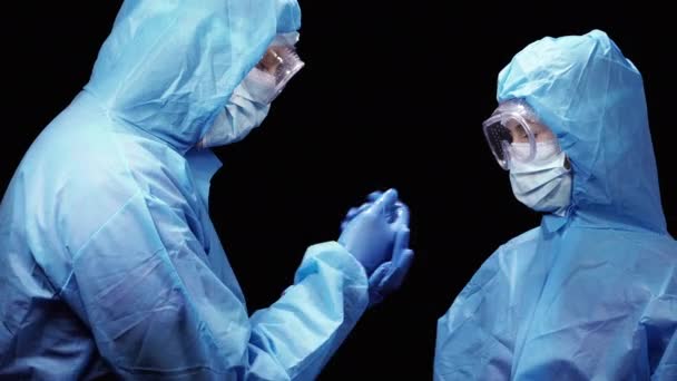 Virus Two Doctors Protective Antiviral Suit Disinfect Each Other Hands — Stock Video