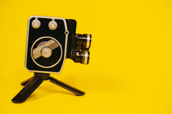 Retro camera. A retro camera stands on a tripod.