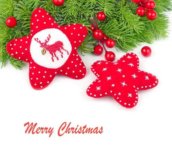 Red textile Christmas stars on branches of a Christmas tree on a white background with space for the text. — Stockfoto