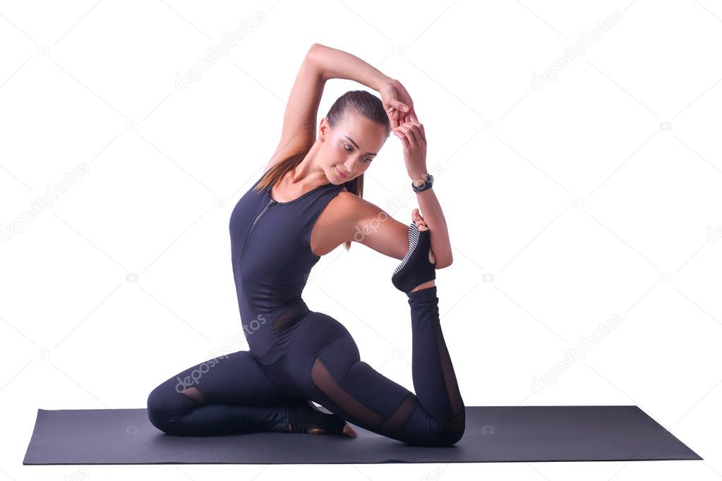 Beautiful sports girl isolated on white background doing yoga in pigeon pose.Healthy lifestyle concept