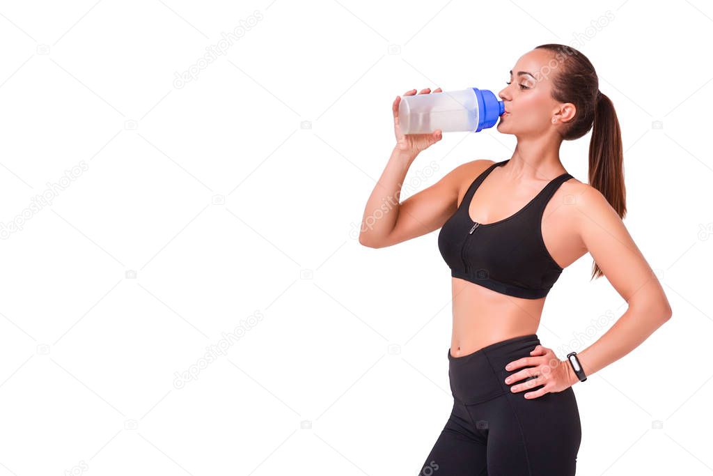 Beautiful sporty woman isolated on white background drinking water from an eco bottle.