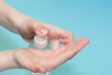 Bir çocuk ellerine antiseptik serpiyor. Virüs koruması. Virüs ve bakterilere karşı korunmak için klorheksidin kullanımı