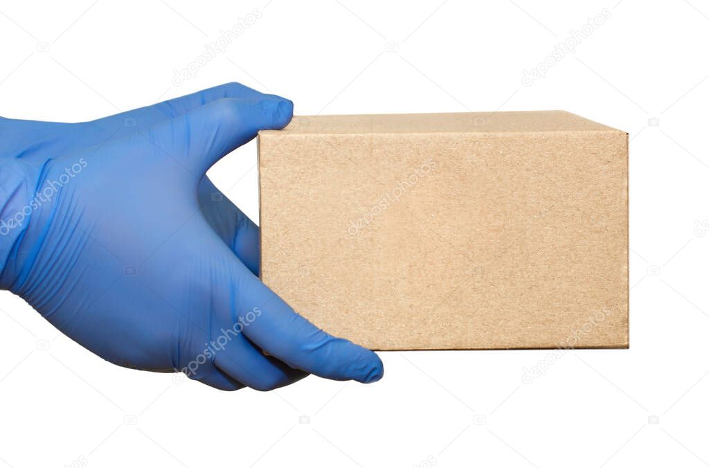 Hand in blue medical glove gives cardboard box.?oncept of safety mail goods courier delivery in virus or coronavirus quarantine. ?opy space on white background