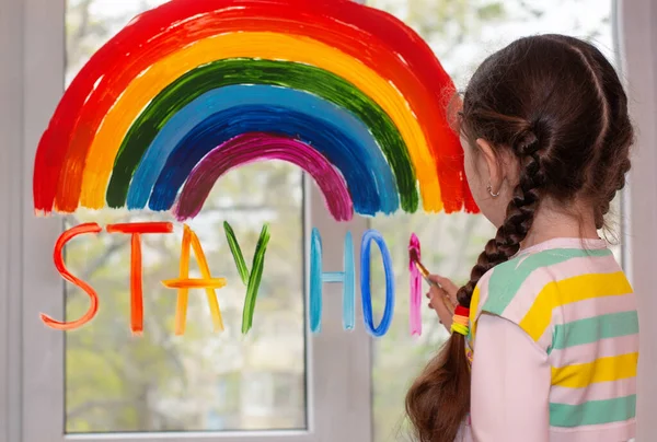 Girl Paints Rainbow Window Writes Text Stay Home Multicolored Letters — стоковое фото