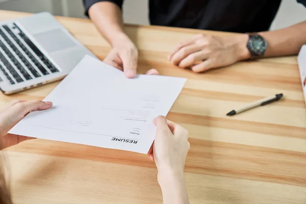 Junge Frau reicht Lebenslauf beim Arbeitgeber ein, um Bewerbung zu prüfen. Das Konzept stellt die Fähigkeit des Unternehmens dar, mit der Position des Arbeitsplatzes übereinzustimmen. — Stockfoto