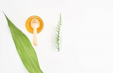 Tatlım cam ve kaşık kolay karıştırma için yuvarlak şekli var. Beyaz arka plan üzerinde mockup için. Doğal güzellik ürünleri kavramı.