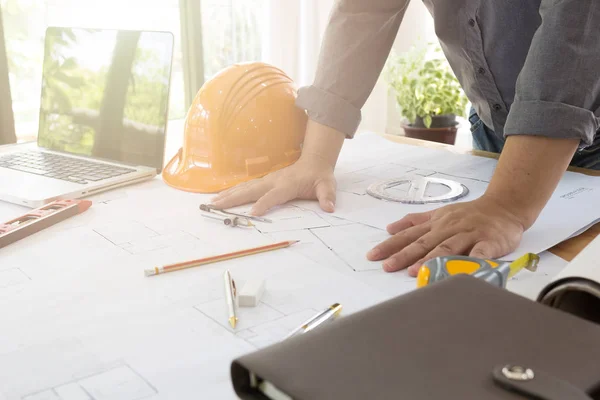 İç mekan tasarımcısı veri ve iş belge ve grafik tasarım diyagramı ile dijital tablet ve bilgisayar laptop kavram olarak ahşap masa üzerinde tartışıyor