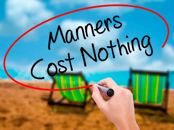 Man Hand writing Manners Cost Nothing with black marker on visua — Stock Photo, Image