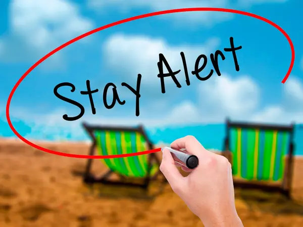 Man Hand writing Stay Alert with black marker on visual screen — Stock Photo, Image