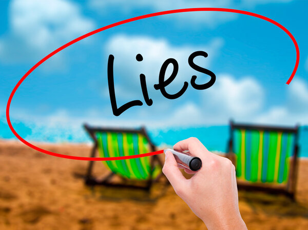 Man Hand writing Lies with black marker on visual screen