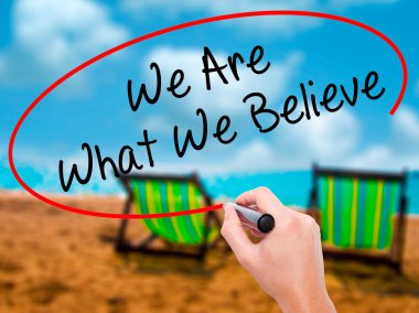 Man Hand writing We Are What We Believe with black marker on vis clipart
