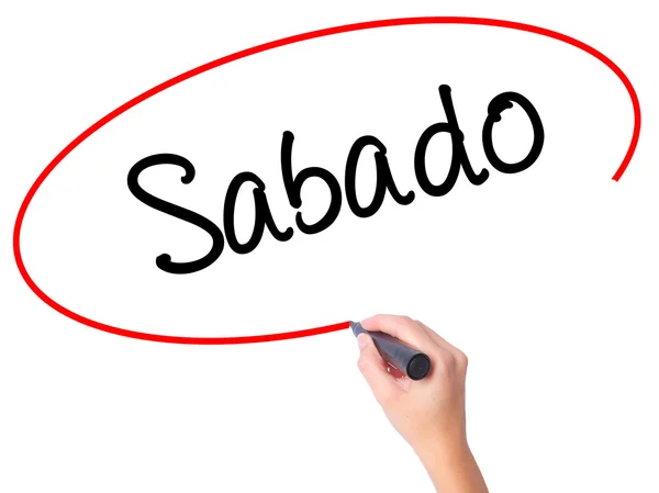 Women Hand writing Sabado (Saturday in Spanish / Portuguese) with — стоковое фото