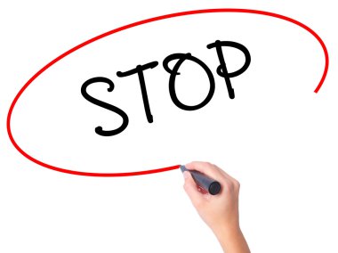 Women Hand writing STOP with black marker on visual screen. clipart